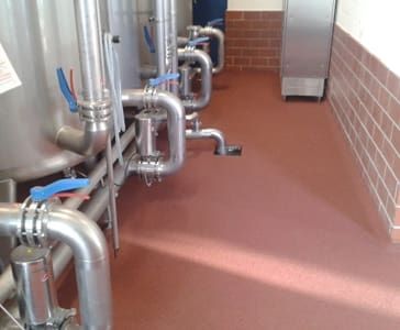 A red coating in a company building with stainless steel machines