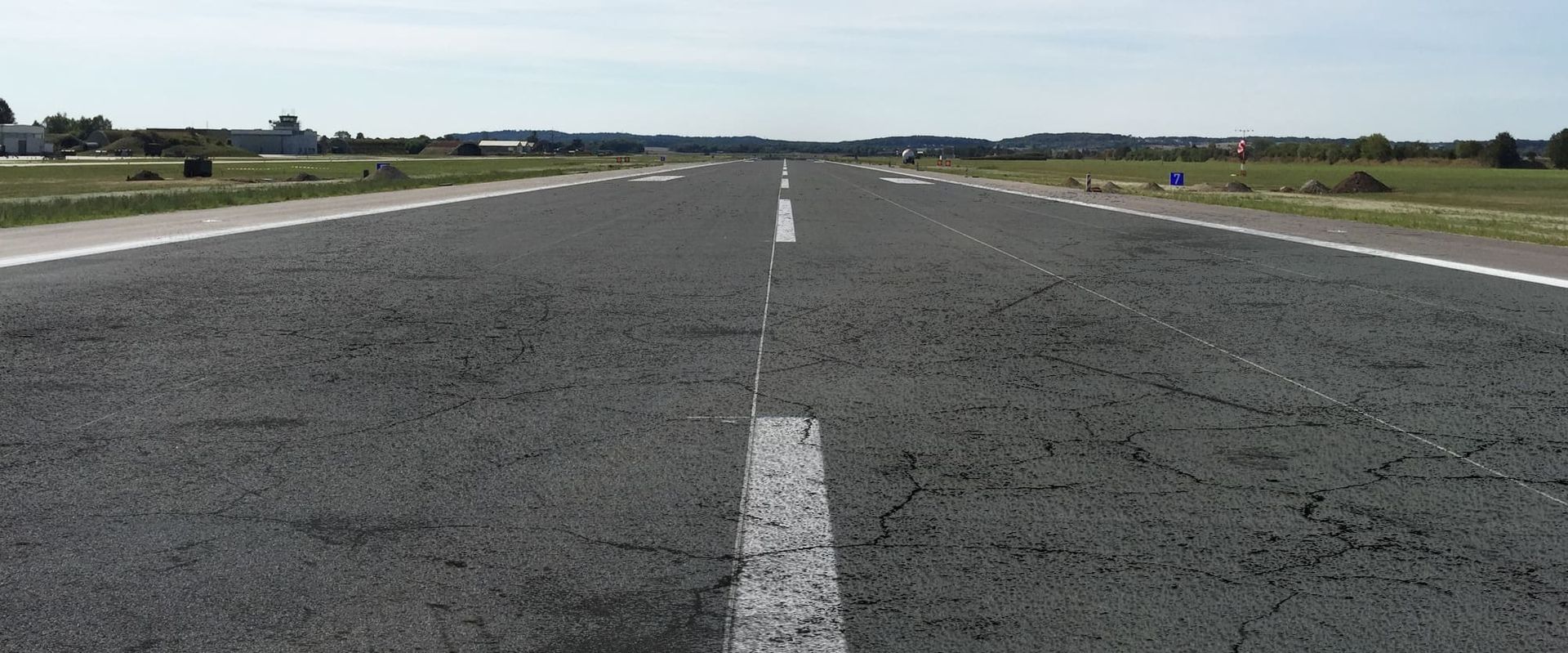 A flight path before the repair with a lot of damage to the asphalt